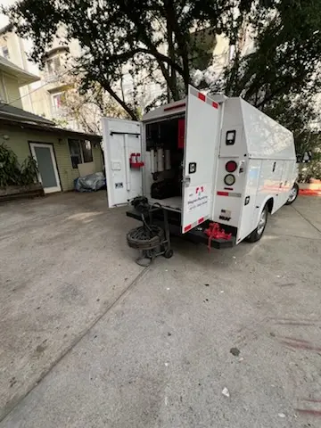 Magnet Plumbing service vehicle on-site for Grease Trap Cleaning in Garden Oaks